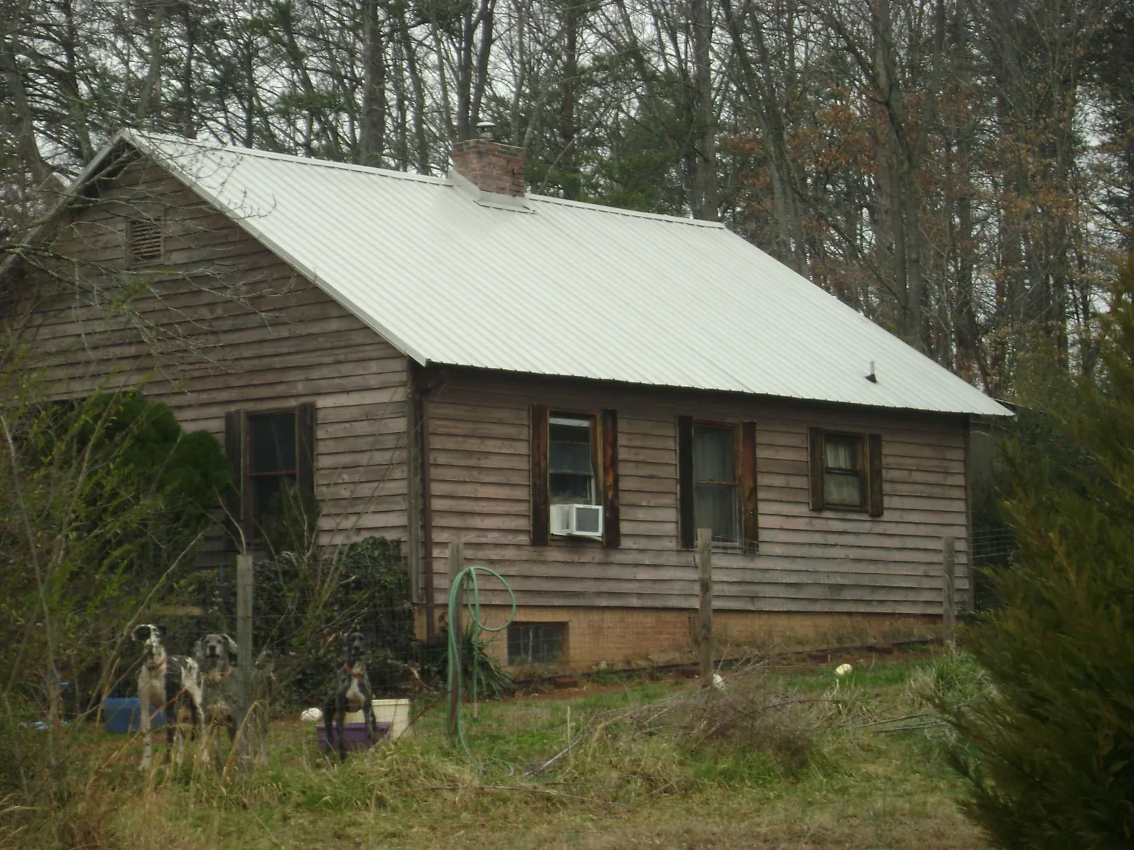 White metal roof on an old wood sided farmhouse, from a Metal Roof Installation job in Nuremberg